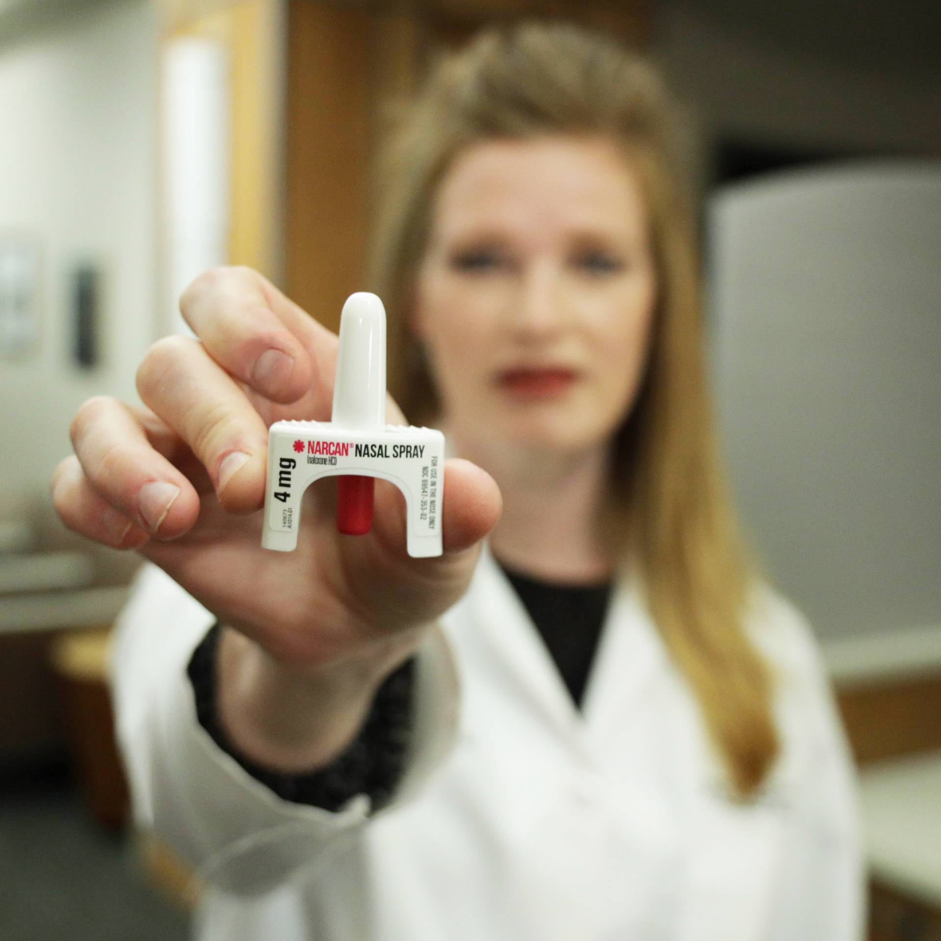 Dr. Holly Geyer holding a Narcan nasal spray unit