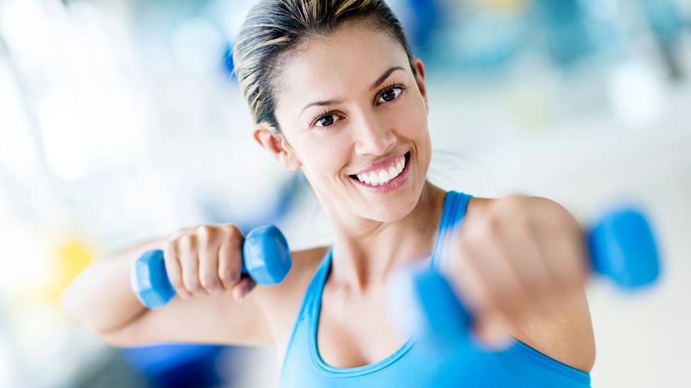 Strong woman weightlifting at the gym